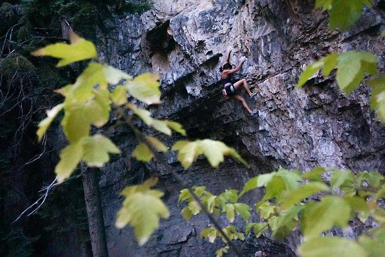 Female rock climber leading in American Fork Canyon.