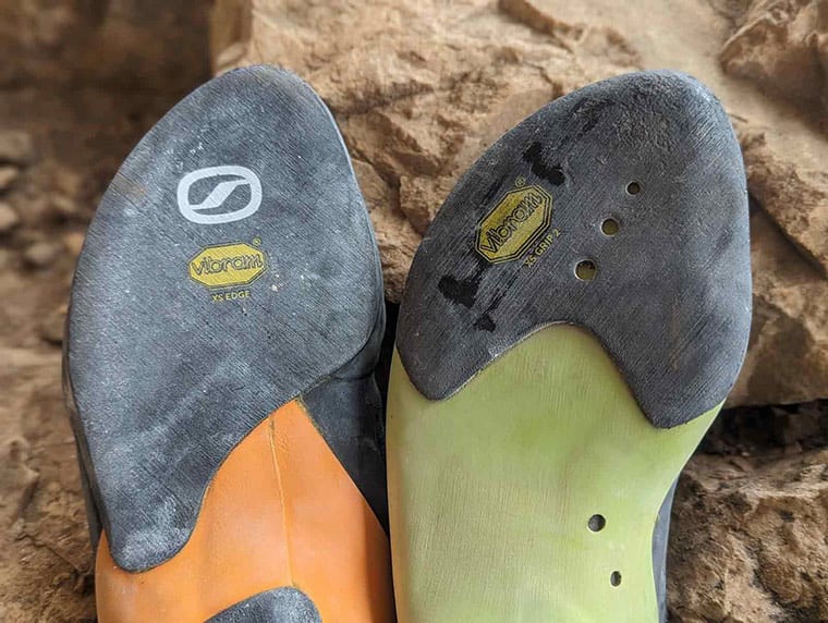 Soles of two different SCARPA climbing shoes showing Vibram XS Edge and Vibram XS Grip 2 rubber