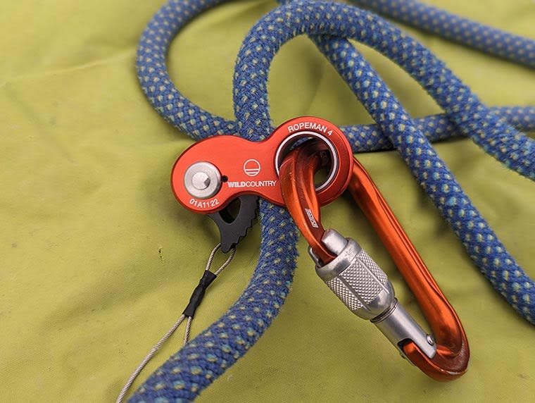 A Ropeman 4 attached to a blue climbing rope with a Petzl Attache carabiner attached