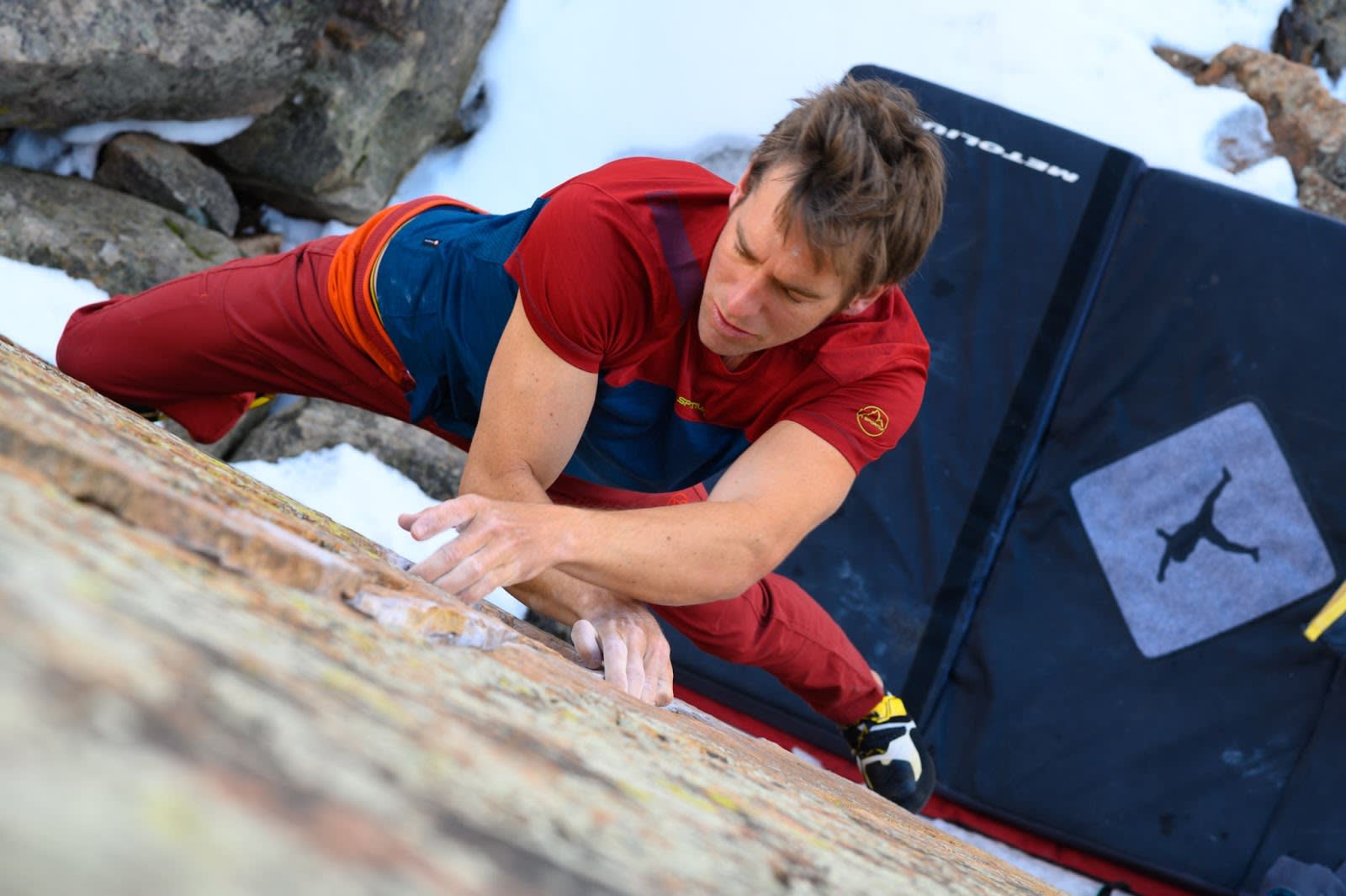 Climber edging on a boulder wearing the Solution climbing shoes