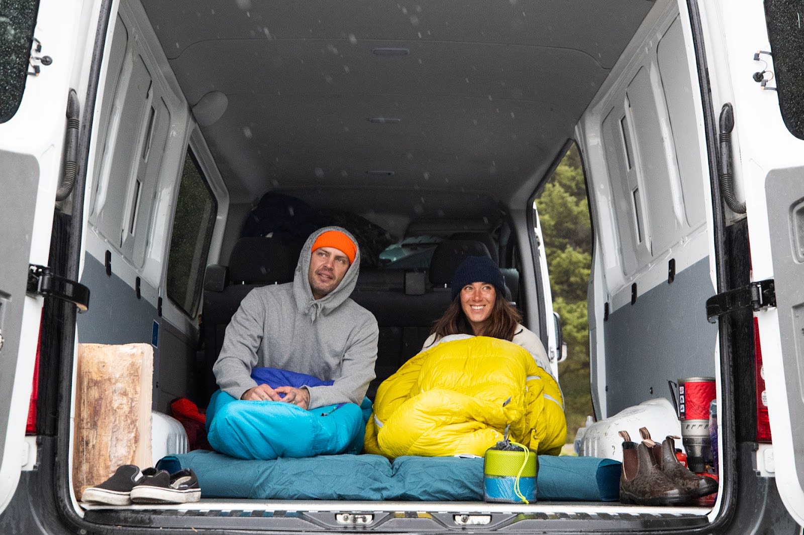 Two campers sitting on the Mondoking in their van