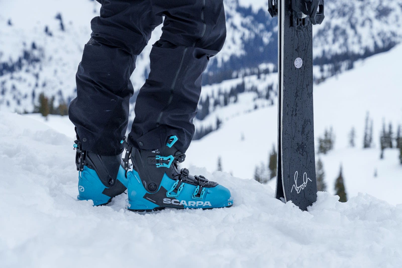 Close up of a person wearing the SCARPA 4-Quattro XT ski boot in the snow