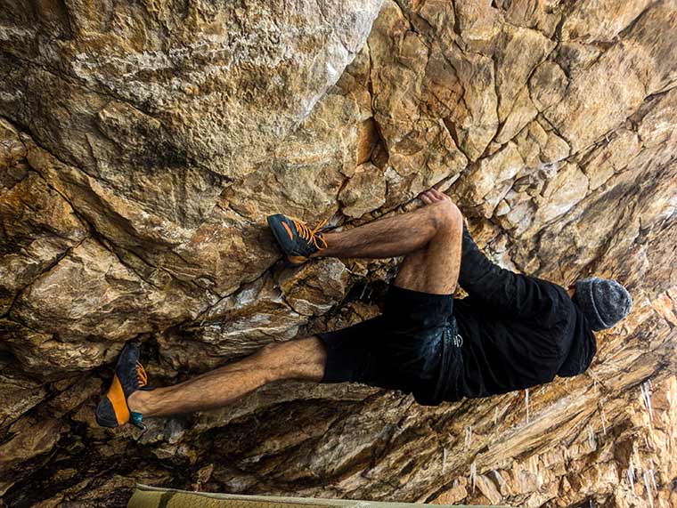 Climber heel hooking while wearing the SCARPA Instinct lace climbing shoe