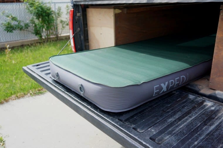 Two, one-way valves one the Exped MegaMat 10 Sleeping Pad in the bed of a truck.