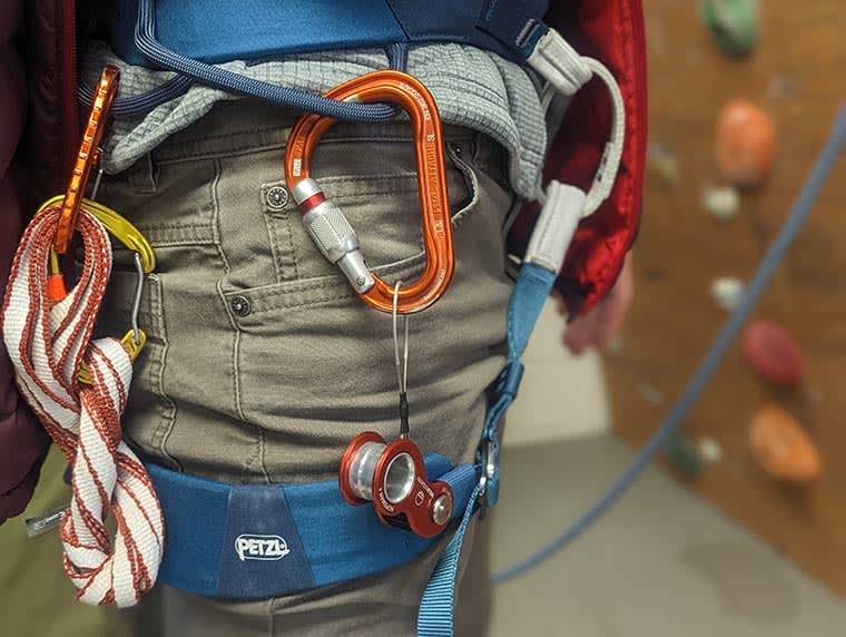 Close up of the Ropeman 4 handging from the side of a climber's harness.