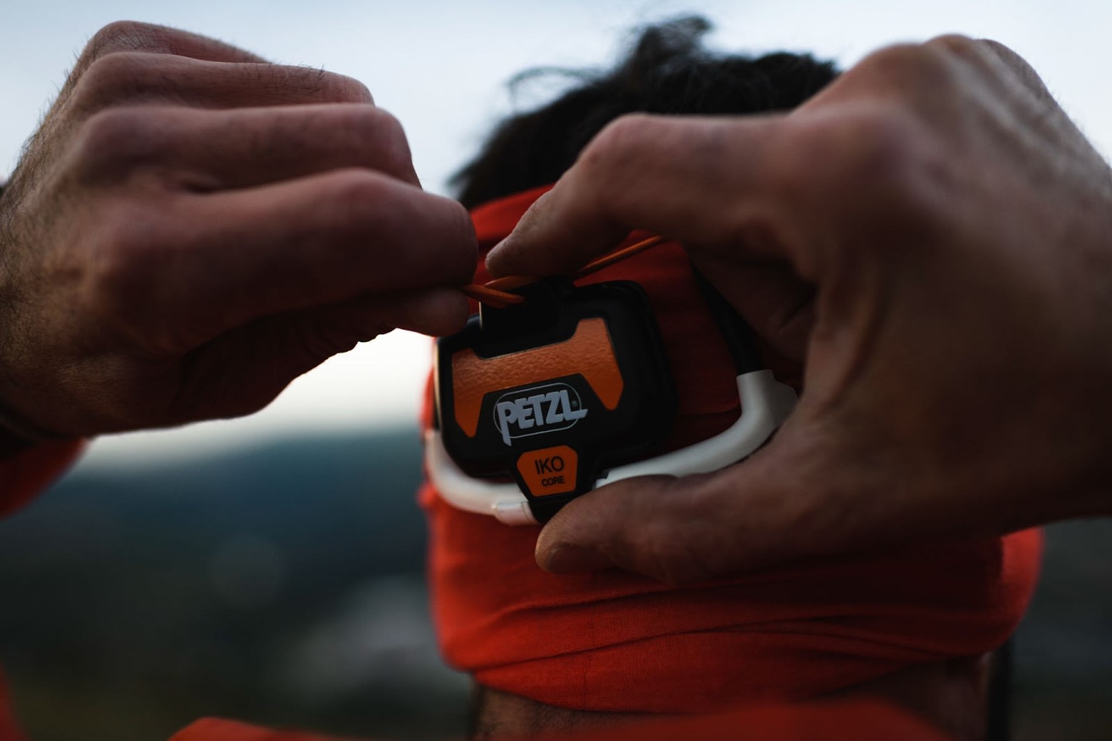 Person adjusting the IKO CORE using the AIRFIT headband on their head