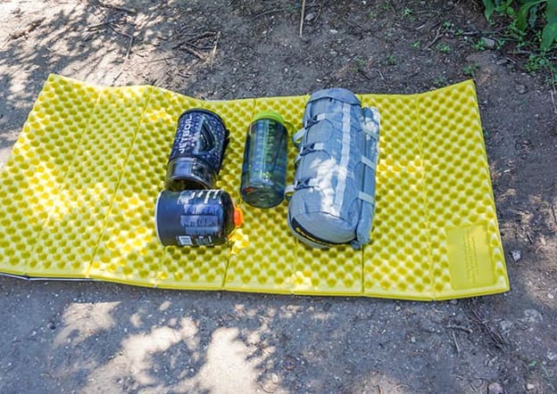 Fly Creek HV UL2 Bikepack Tent in stuff sack next to a Nalgene bottle and a Jetboil stove for scale