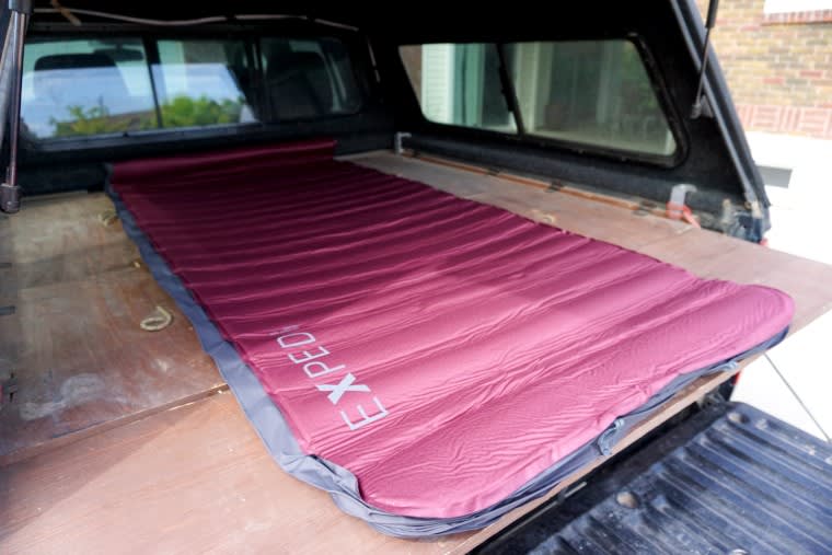 Unrolled Exped Megamat Max 15 Sleeping Pad, ready to be inflated in the back of a truck.