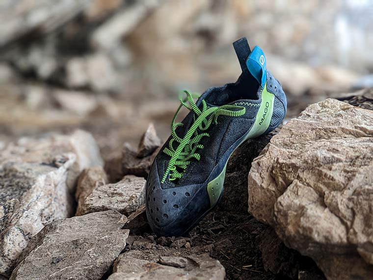 A front view of a single Mago shoe sitting by itself on the rocky ground