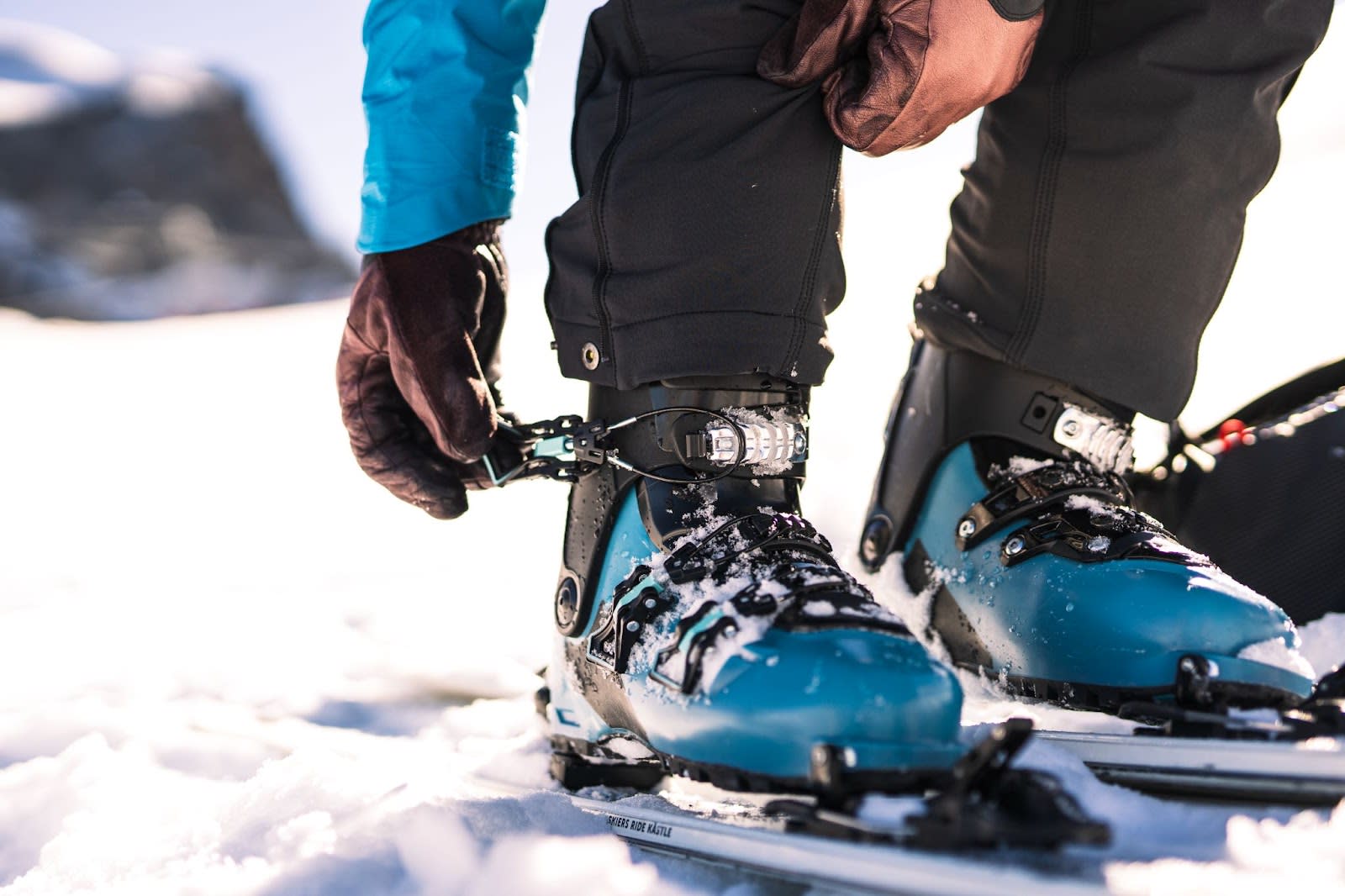 Close up of a skier buckling their ski boot straps