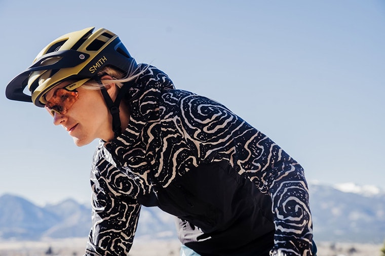 woman rides by while wearing a smith forefront 2 helmet