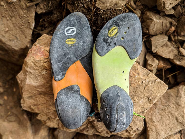 The bottom of the Instinct next to the Mago climbing shoe showing the 2/3-Length Outsole