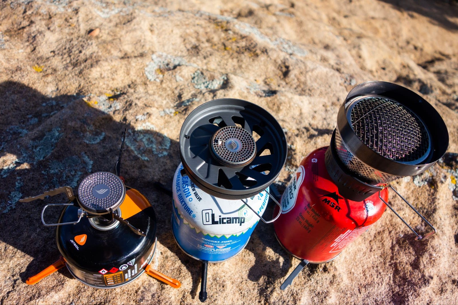 The Stash, Flash, and Windburner cooking systems set up in a row