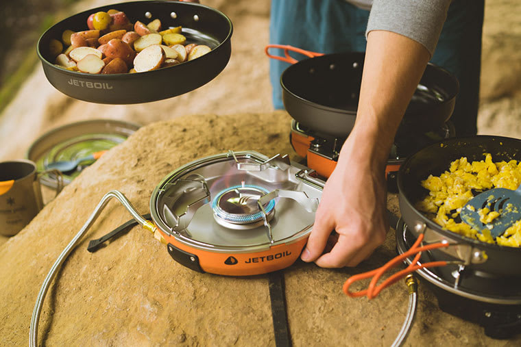 Using the dial to turn up the heat to saute vegetables on the Jetboil Genesis camp stove