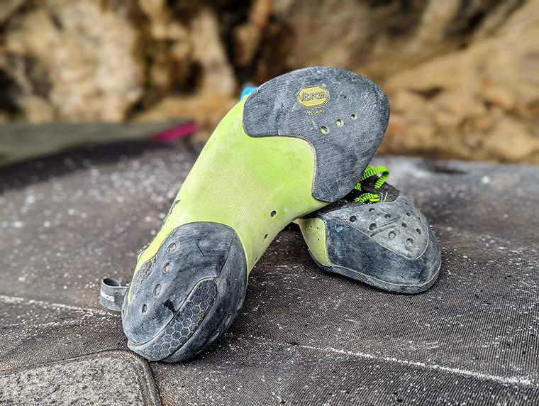 A pair of the Mago climbing shoes on a bouldering pad showing the Vibram XS Grip 2 rubber