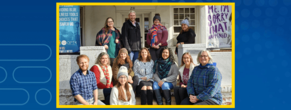 photo of full Student Wellness staff sitting outside the main office (231 S. College) in winter attire.