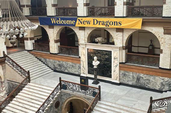 "Welcome New Dragons" banner hanging in building