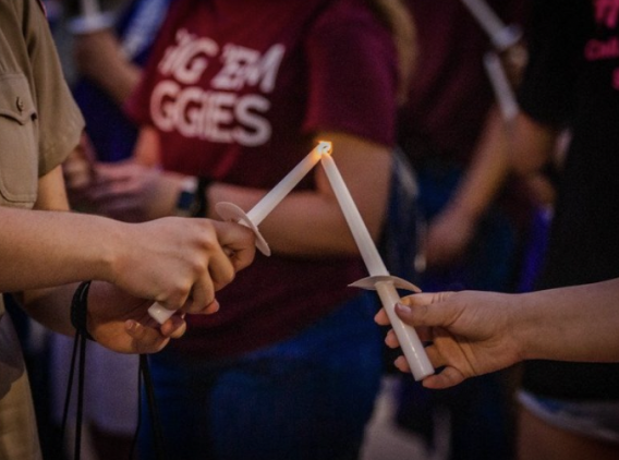 People holding candles. 