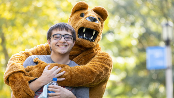 The lion mascot hugging a person at Behrend's Parents, Families, & Alumni Weekend in 2021