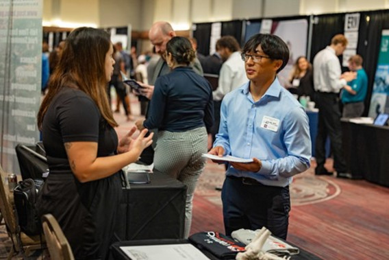  Student talking to a person at a Texas A&M Career Fair