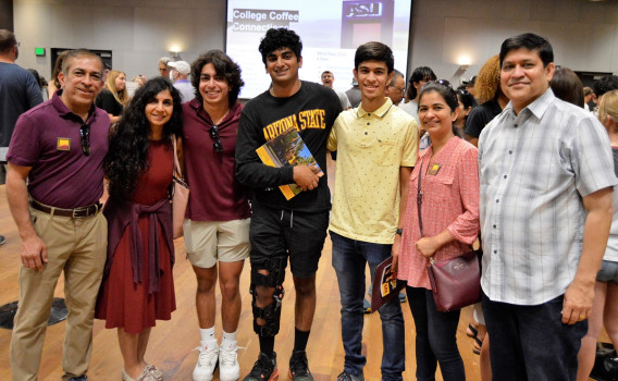 Two ASU families of parents and students pose together during a past ASU Family Welcome Open House