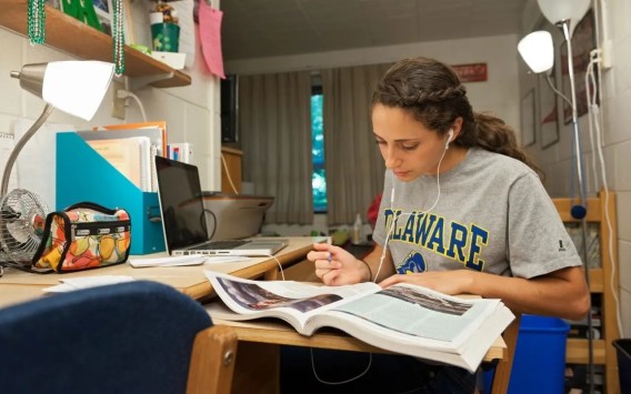 a photo of a student reading a textbook