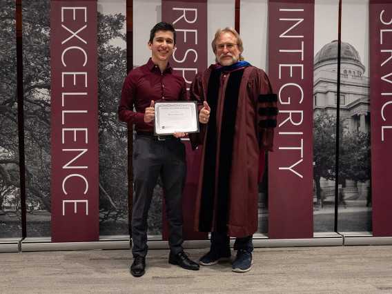 Michael Davila ’23 and Professor Andrew Conkey at a graduation celebration at the McAllen campus