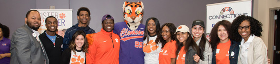 Group of people smiling with Clemson tiger