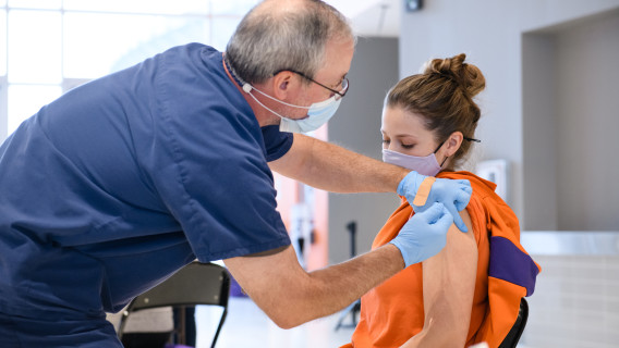 A student athletic trainer receives a COVID-19 vaccine in January 2021