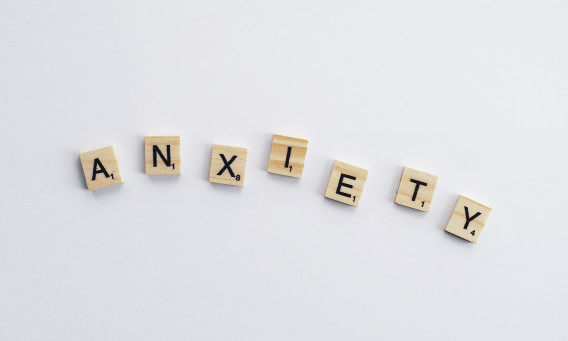 Overhead shot of Scrabble letters spelling out "Anxiety"