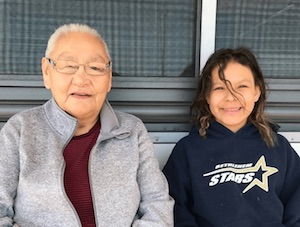 Robyn sits outside with her grandmother Patty