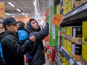 Two teenage Indigenous boys shopping in a supermarket
