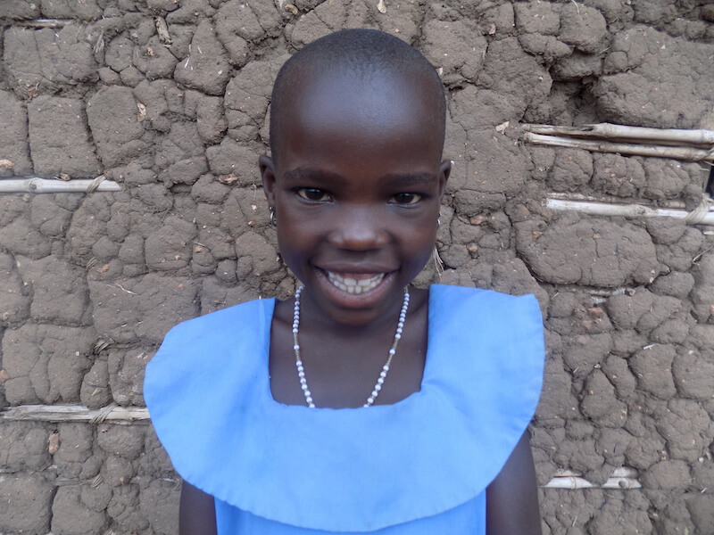8-year-old Immaculate from Uganda smiles at the camera