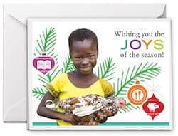 Buy a charity gift for Christmas and receive a free Christmas card showing a smiling African girl and Christmas decorations in the background