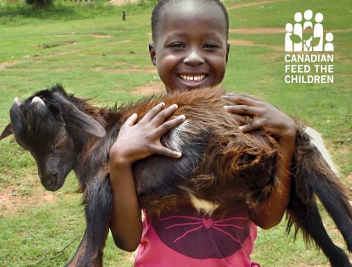 Give a goat and receive this free card showing a smiling African girl holding a goat
