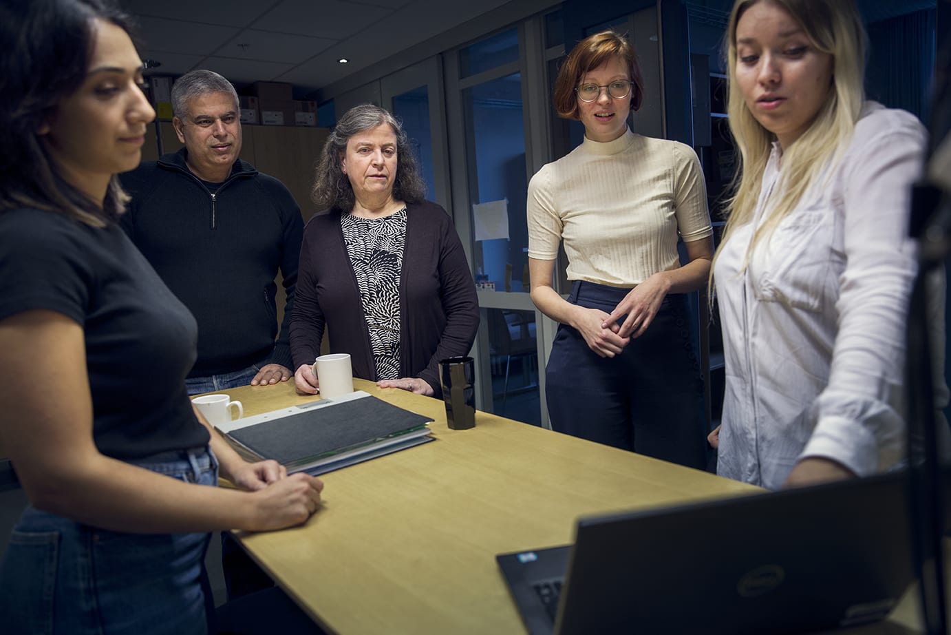 En grupp forskare samlade runt en dator.