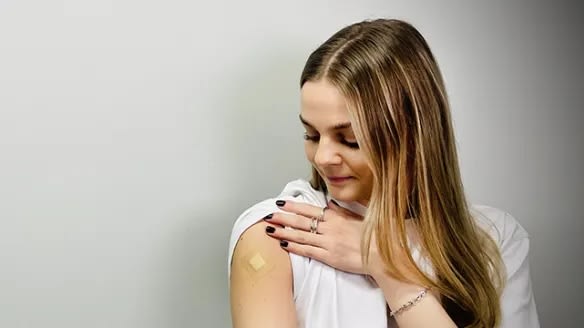 Woman with plaster on her arm