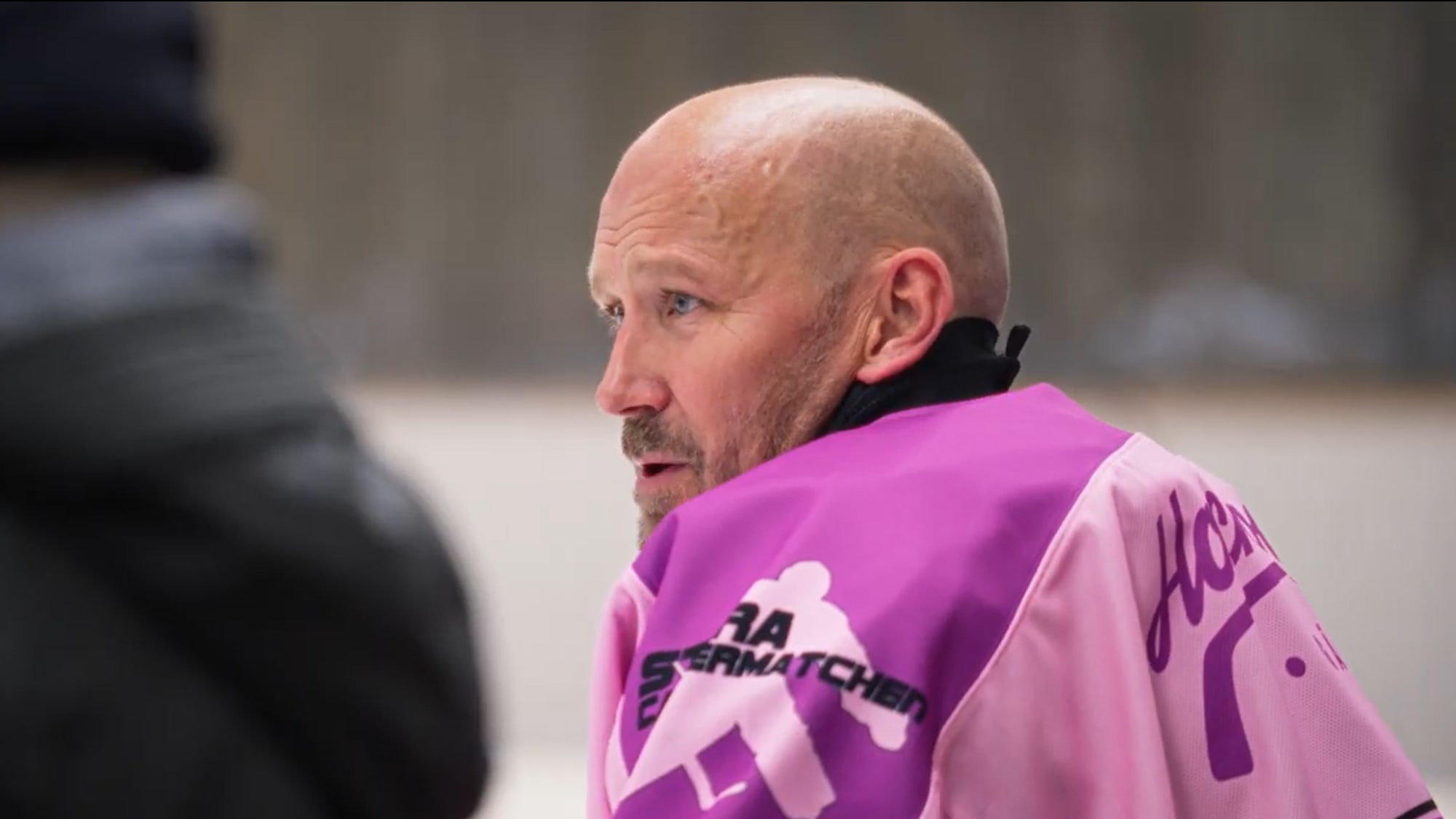 Hasse, arrangör av matchen sitter och tittar ut över isen. 