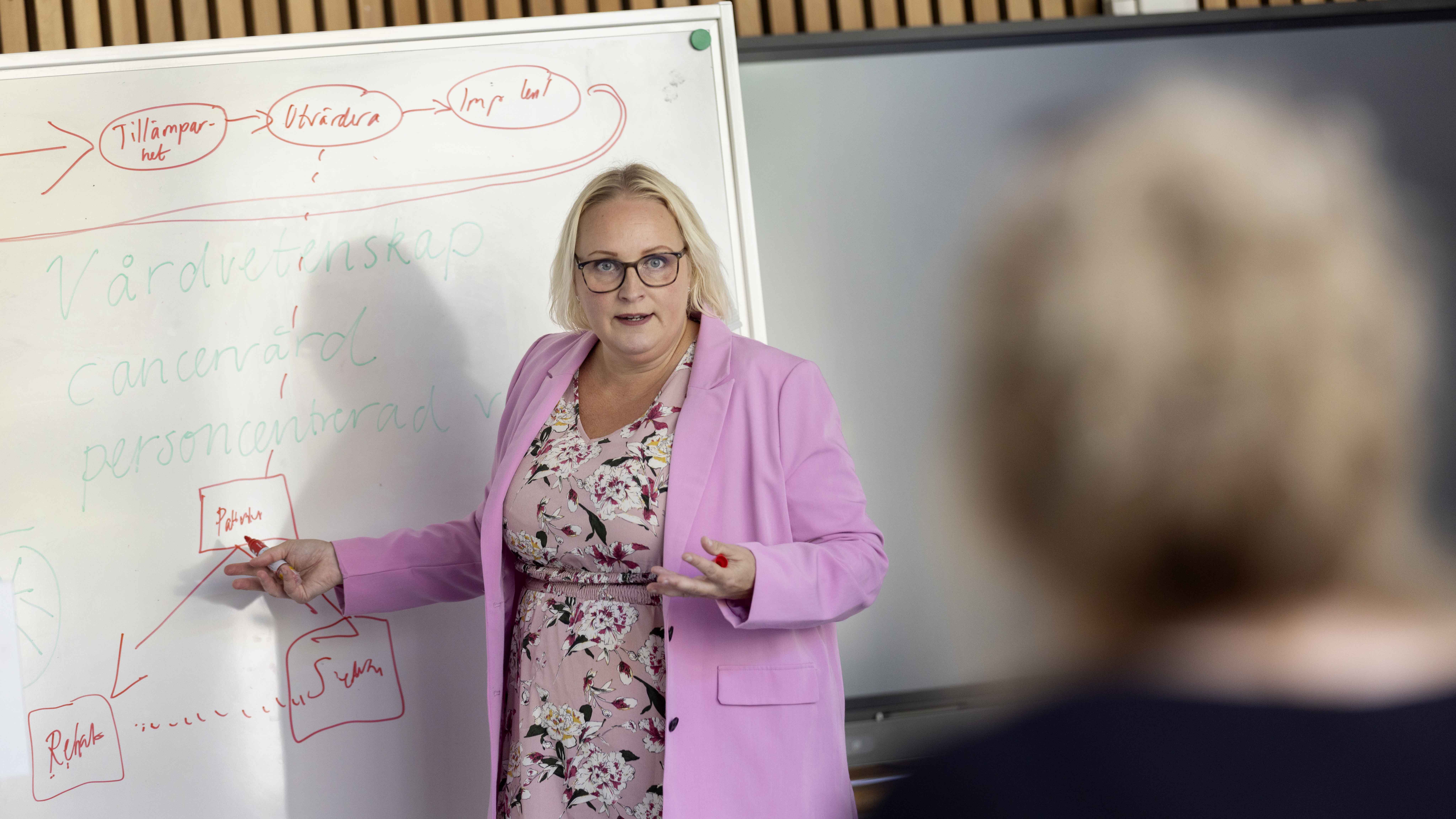 kvinna framför whiteboard
