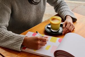 Woman drinking Turmeric Curcumin latte