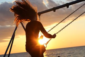 Girl on swing in sun