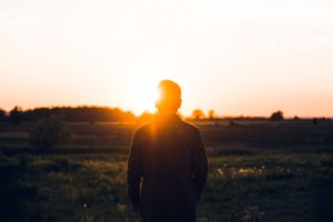 Man alone looking at sunset