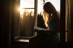 Woman reading book in sunlight