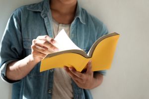 Man reading a yellow book