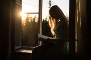 Woman reading book in sunlight