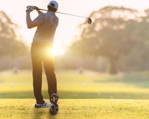 Golfer in morning sunlight