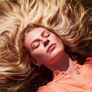 Woman lying in the sun with bright skin