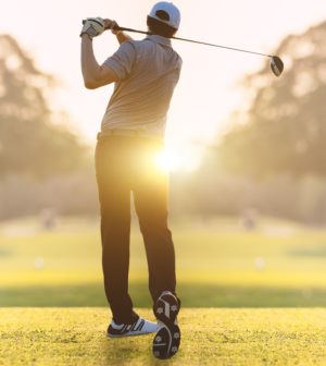 Golfer in morning sunlight