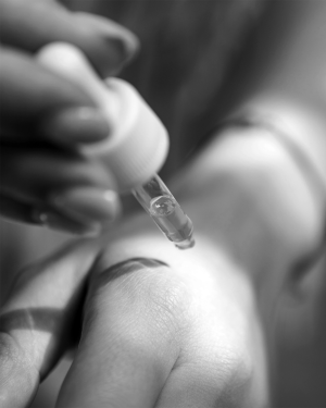 Woman applying CBD oil to wrist