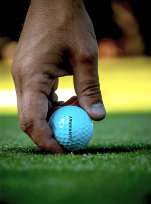 Man holding Cannaray CBD golf ball